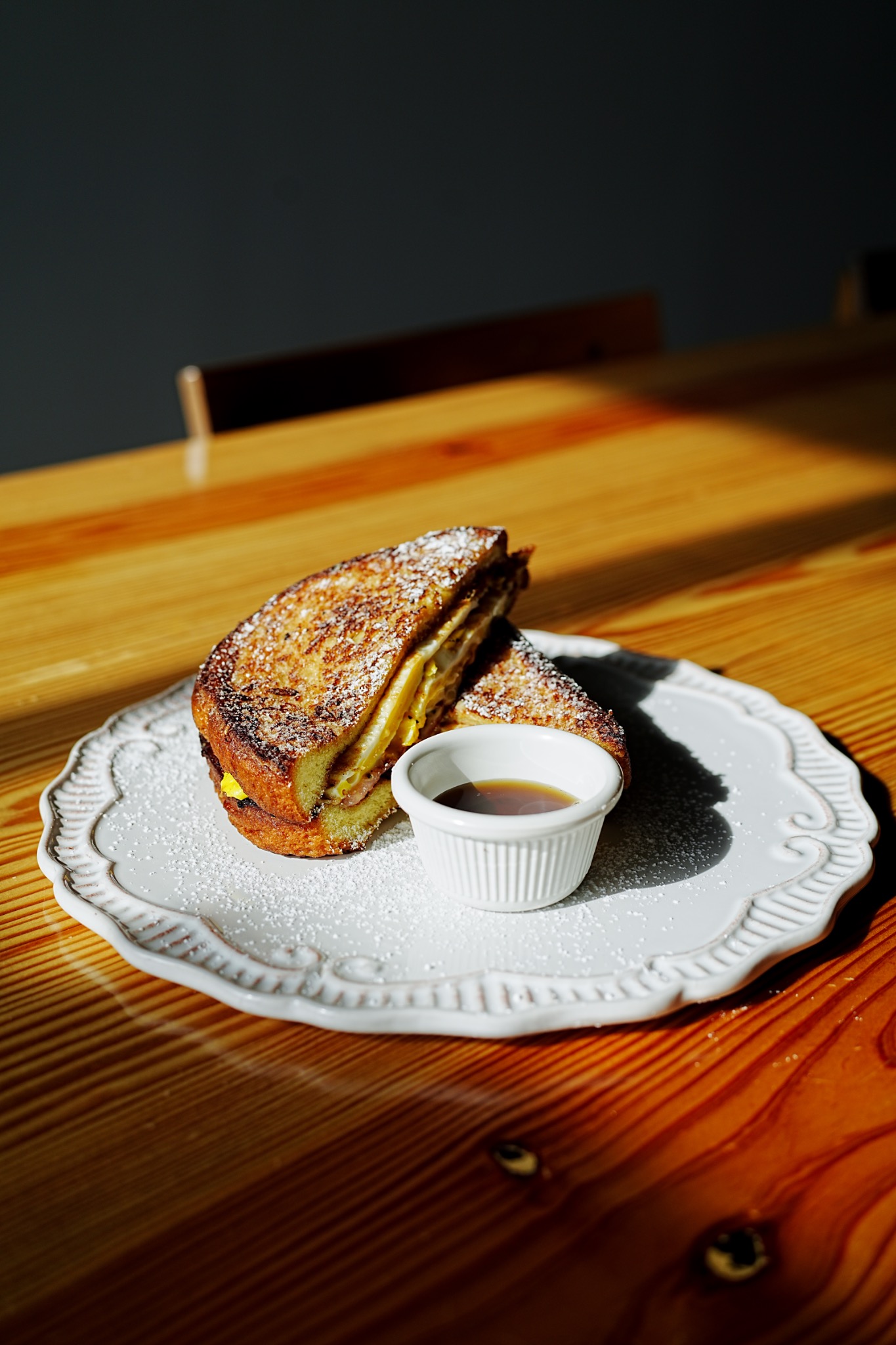 French toast breakfast sandwich served with syrup at Coffee Nutz